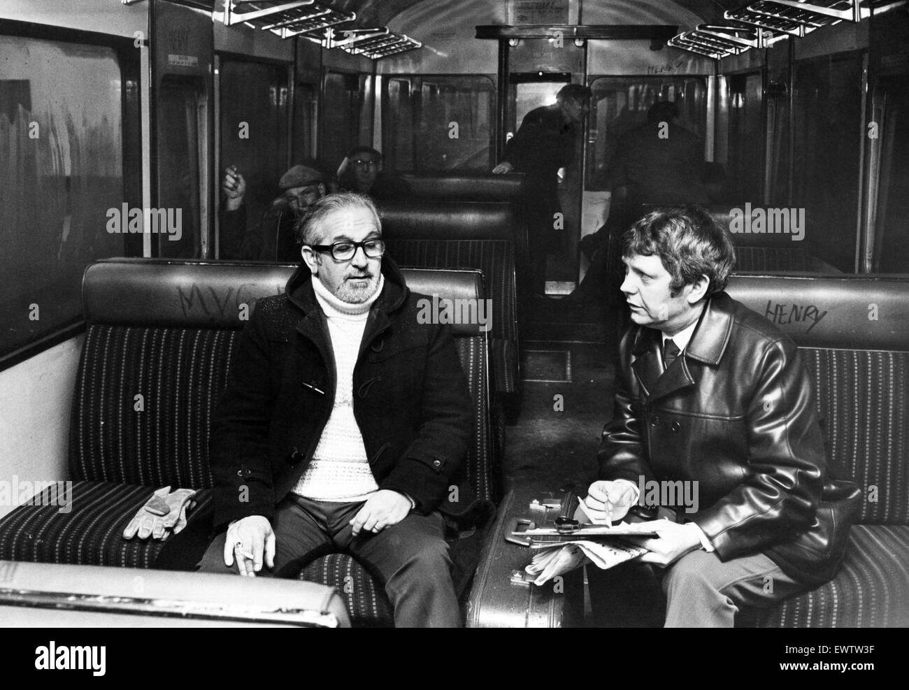 British railway detectives interview passenger on the 4.45 from Rhymney as the train approaches Caerphilly. They are trying to ascertain if anyone had been a passenger on the same train on the day school girl Paula Hughes was attacked, and had seen a yout Stock Photo