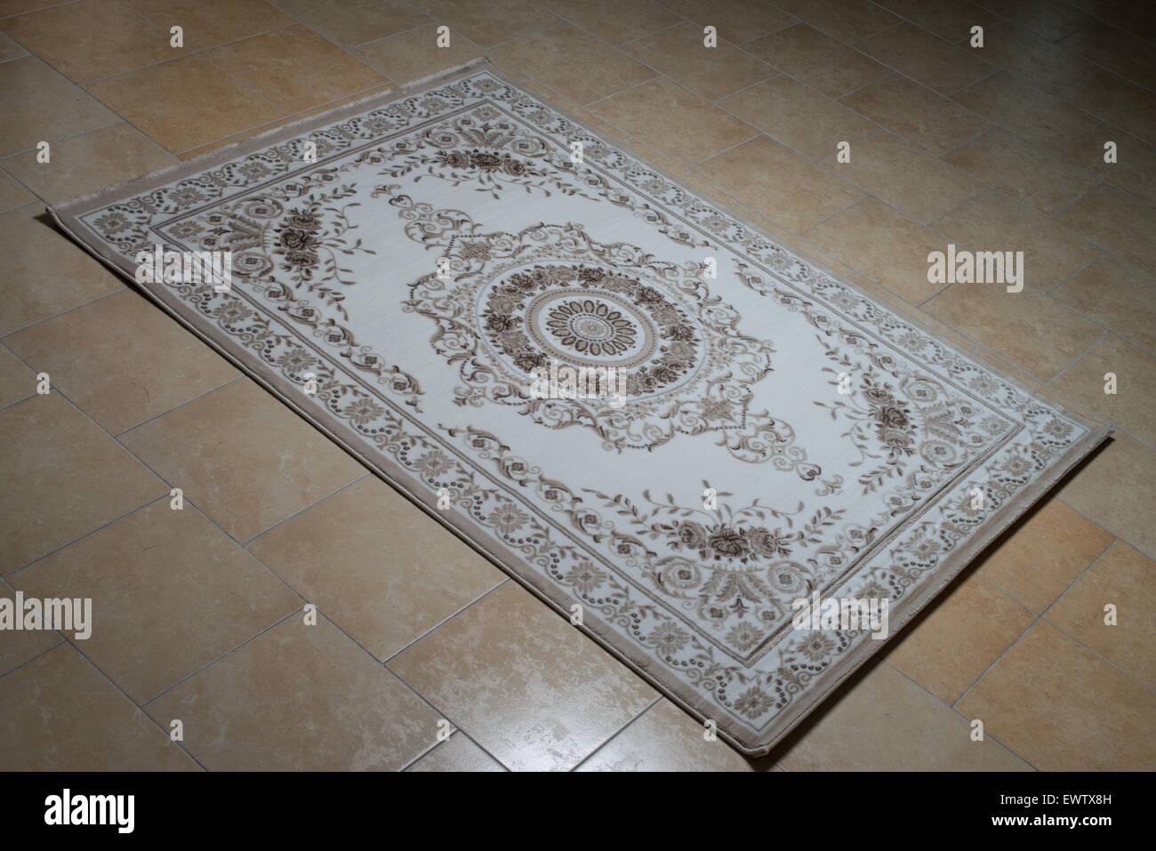 White Persian Rug Isolated On Tiles Stock Photo - Alamy