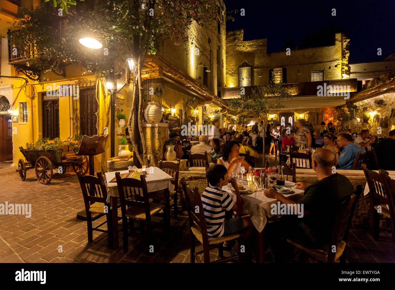 Old Venetian port of Chania Crete Restaurant Greece people street at night Chania taverna bar Crete, Greek Islands Stock Photo