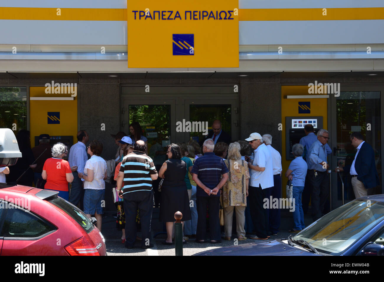Crowd of people queue at Piraeus bank branch open only for pensioners without ATM access. Capital controls in Greece. Stock Photo