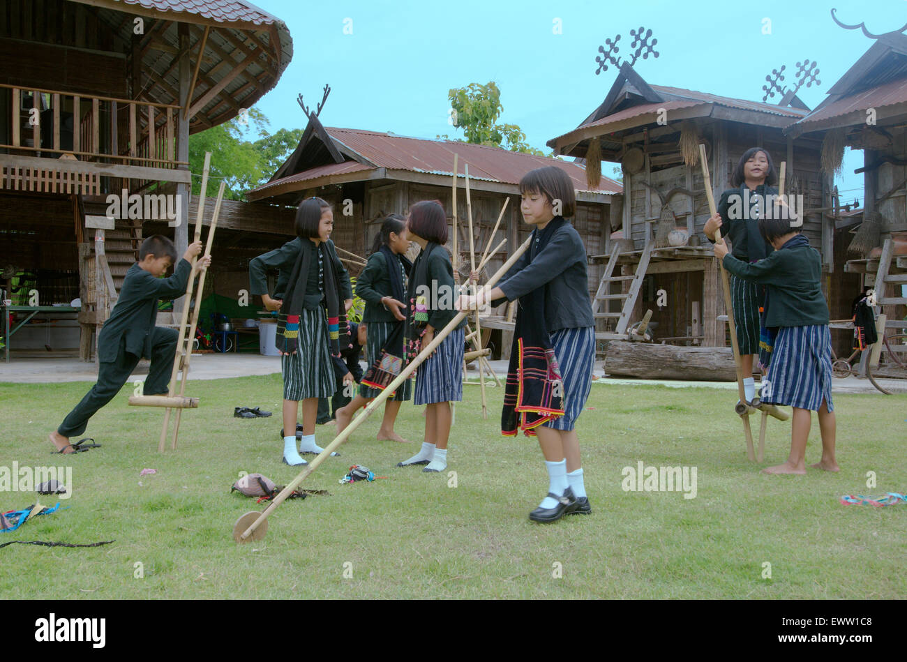 Children Tai Dam  learn to walk on bamboo stilts, Loei province, Thailand Stock Photo