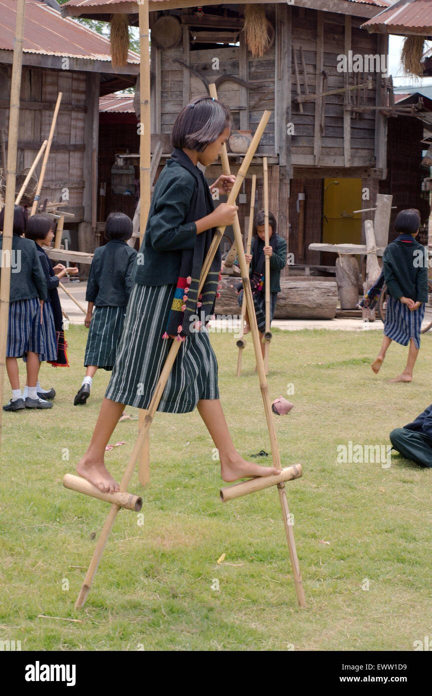 Children Tai Dam  learn to walk on bamboo stilts, Loei province, Thailand Stock Photo