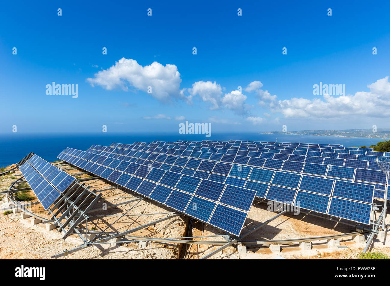 Field of many solar collectors in rows on rotatable circular construction at coast in Kefalonia Greece Stock Photo