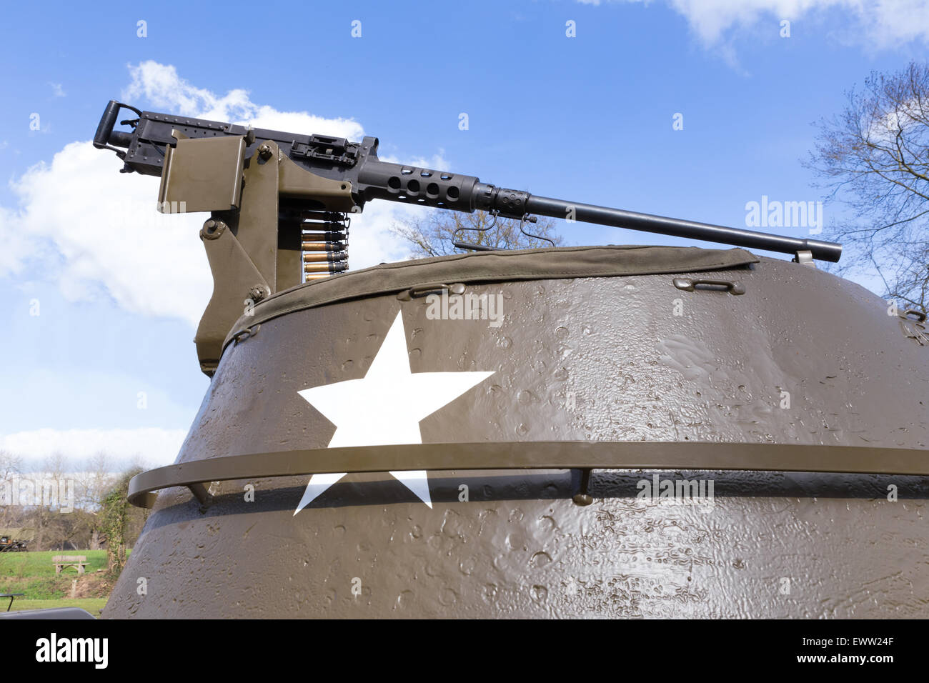 Machine gun on old american tank with blue sky on sunny day Stock Photo