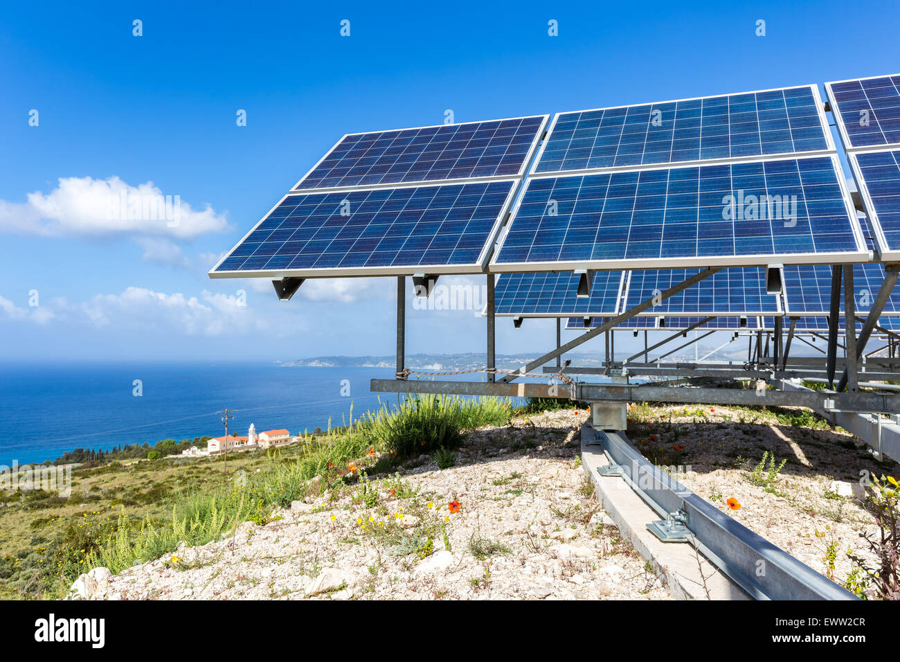 Many blue solar collectors near sea and monastry at coast in Kefalonia Greece Stock Photo