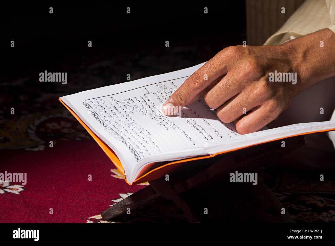 1 indian Muslim man reading Quran book Stock Photo