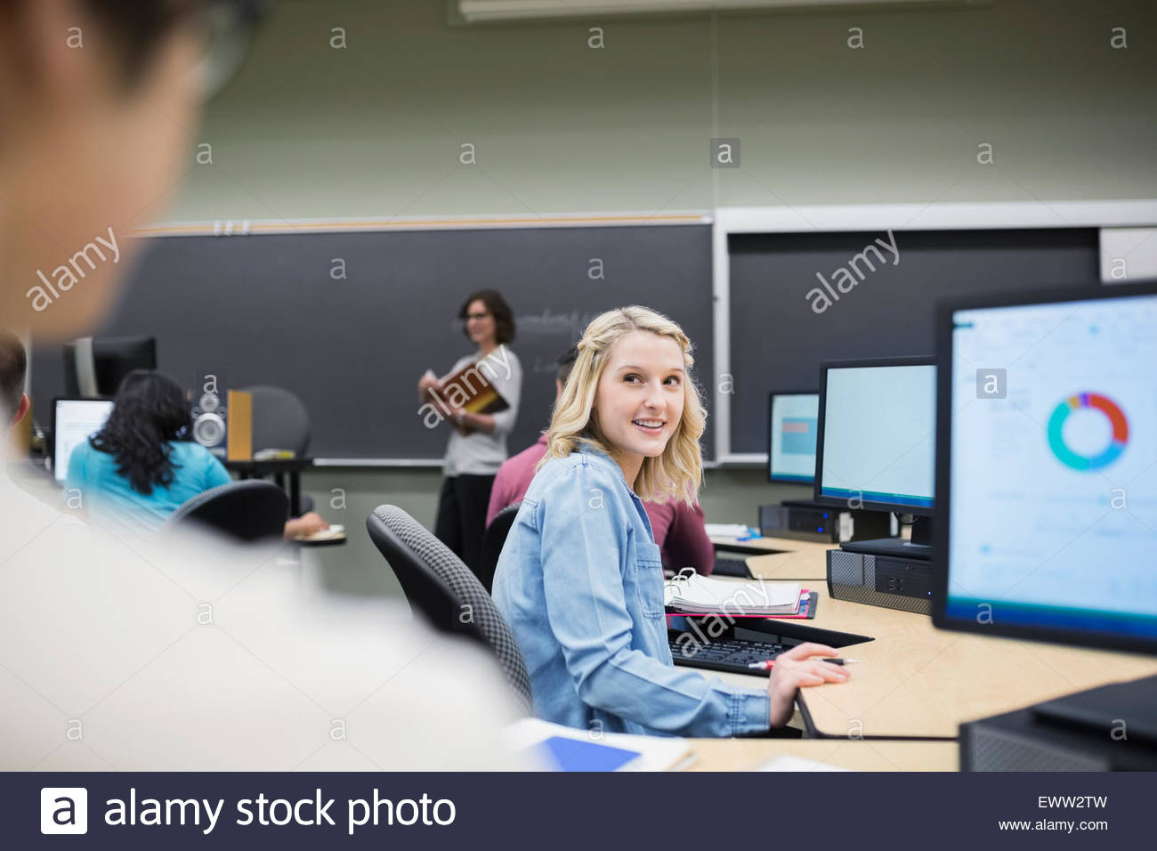 College students studying at computers in classroom Stock Photo Alamy
