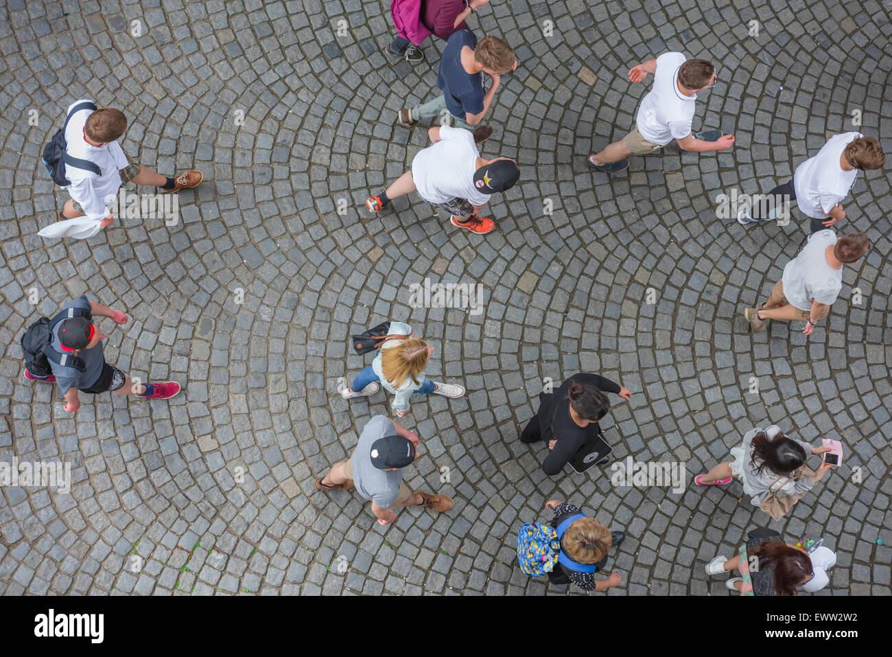 Young people walking, overhead view of people walking across the cobbled surface of the Charles Bridge in Prague, Czech Republic. Stock Photo
