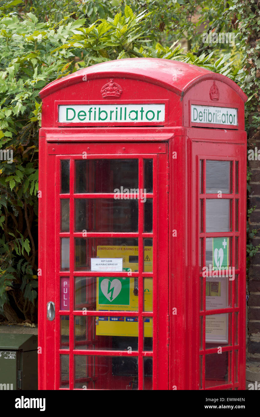 Iconic Red phone box used to store a defibrillator Stock Photo
