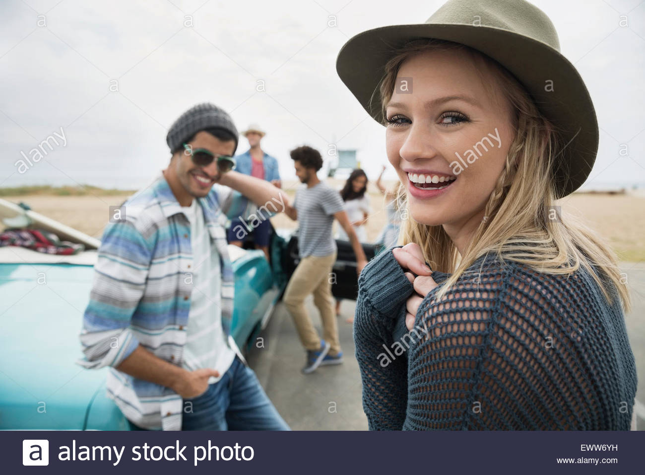 Portrait smiling young woman hanging out friends beach Stock Photo