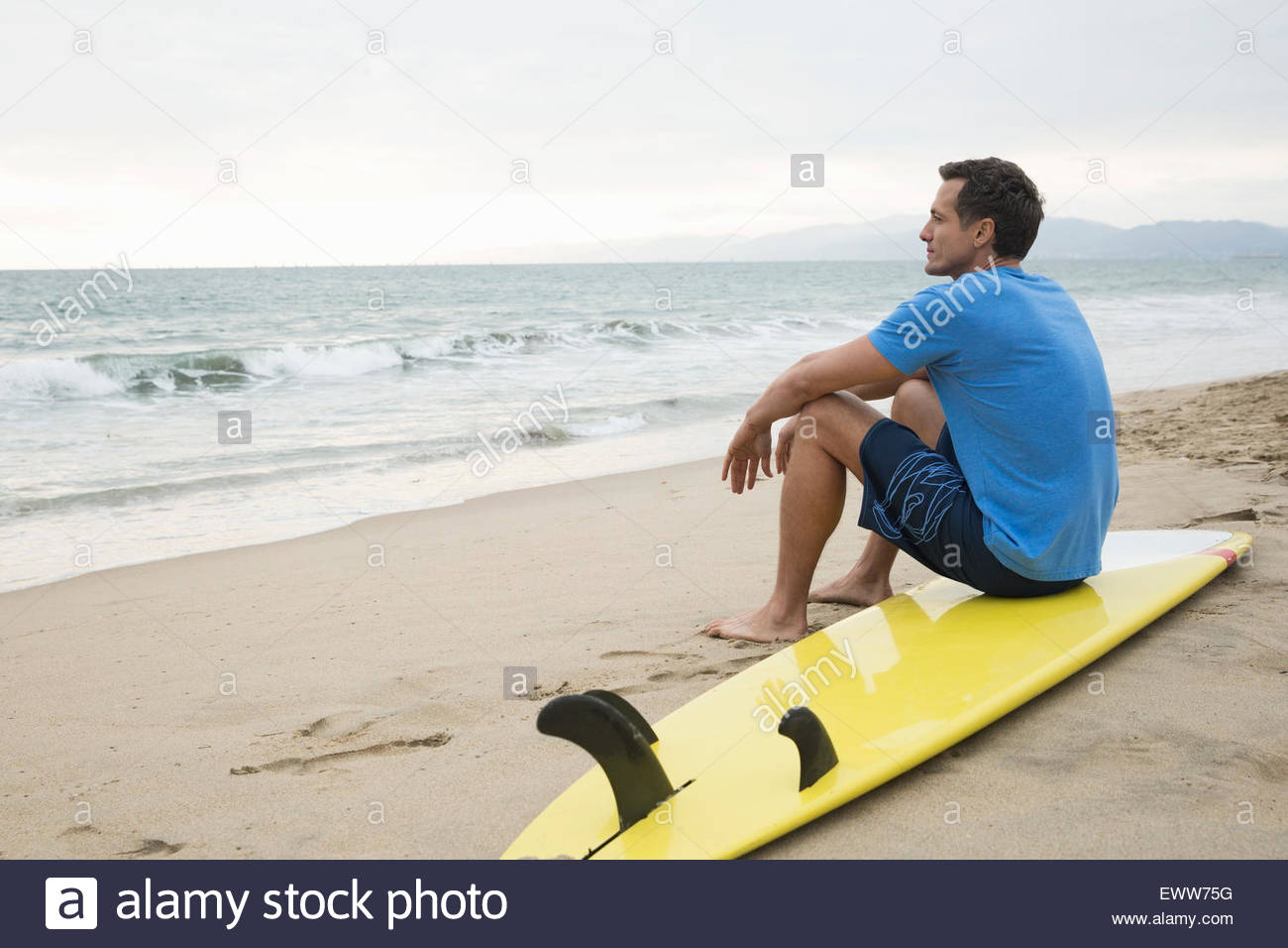 Person sitting on beach hi-res stock photography and images - Alamy