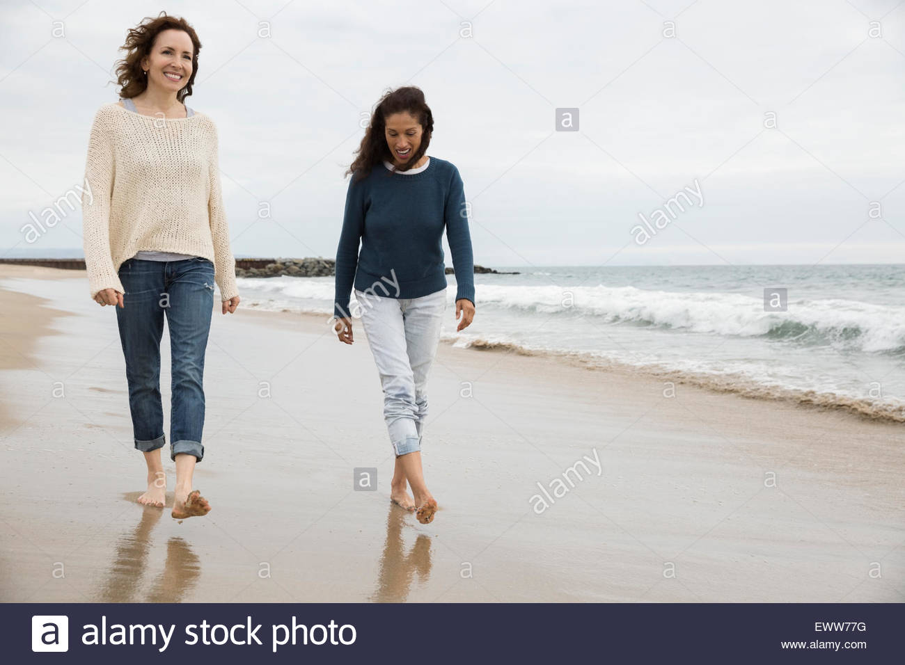 Women walking on beach Stock Photo
