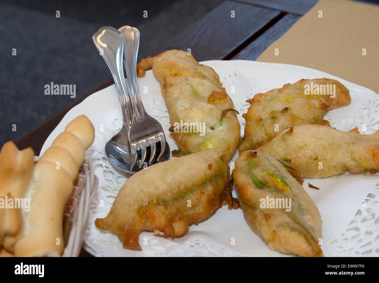 typical italian food fried zucchini flowers in a dish and bread of