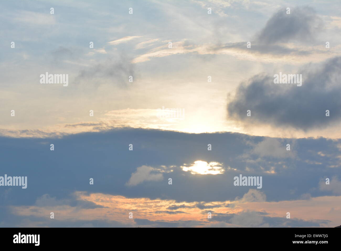 Sun shining through clouds Stock Photo - Alamy