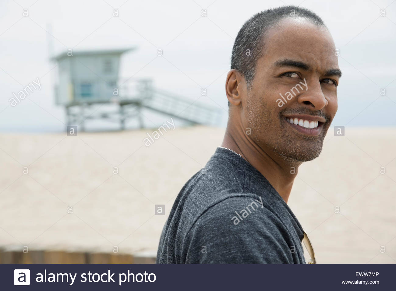 Close up portrait smiling man at beach Stock Photo