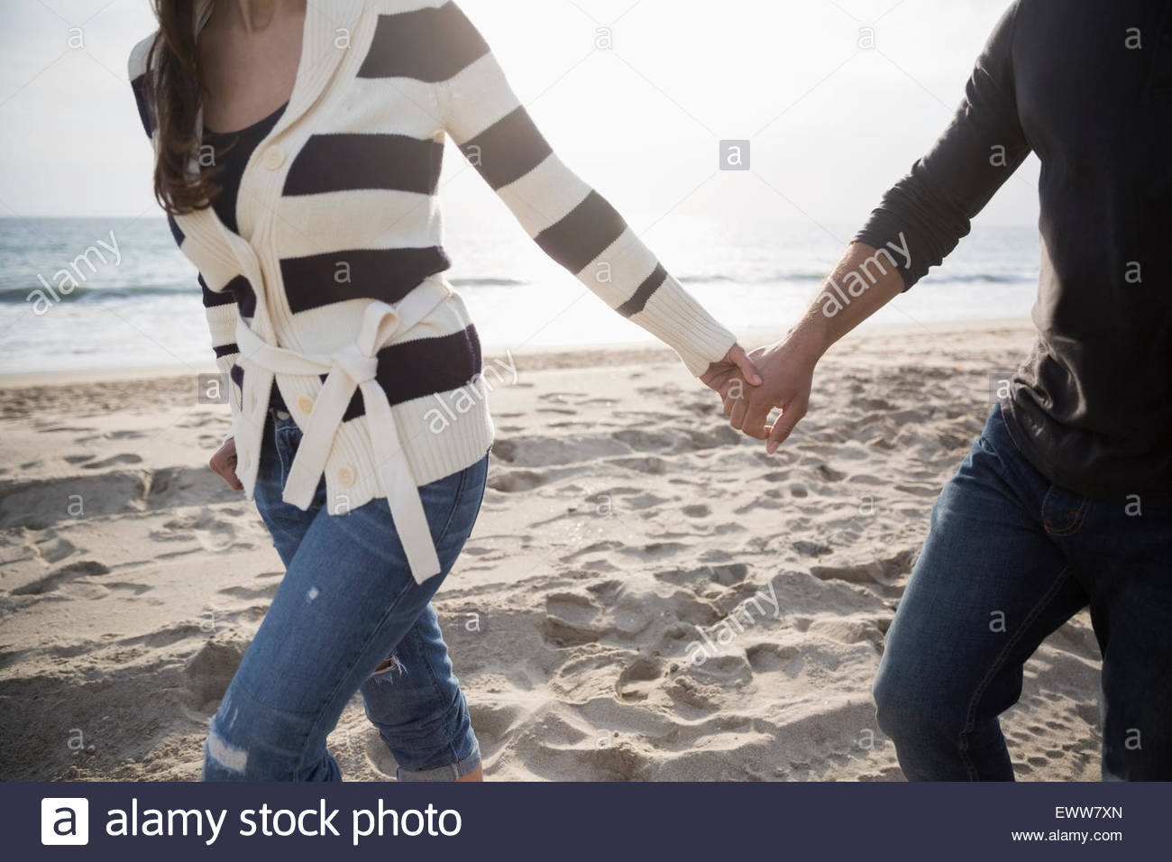 Couple walking holding hands hi-res stock photography and images - Alamy