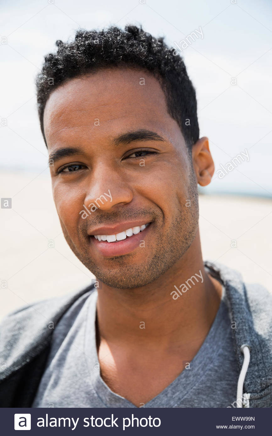 Close up portrait smiling man black curly hair Stock Photo