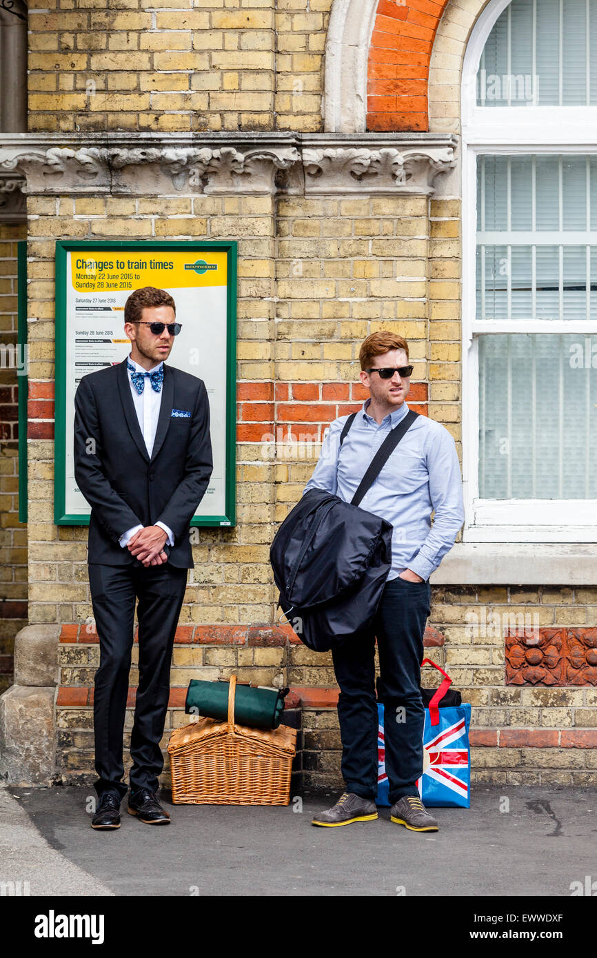 Young Men Waiting At Lewes Station For Transport To Take Them To Glyndebourne Opera House To Watch The Opera, Lewes, Sussex, UK Stock Photo