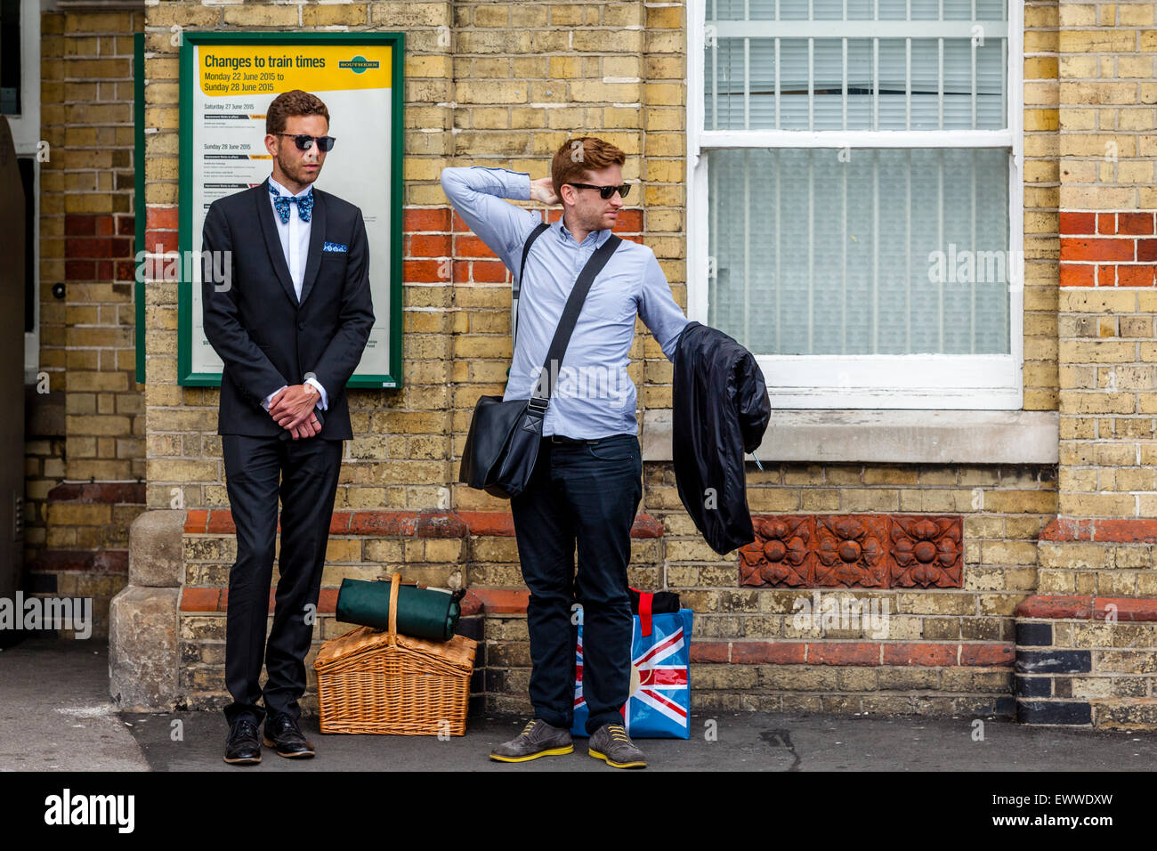 Young Men Waiting At Lewes Station For Transport To Take Them To Glyndebourne Opera House To Watch The Opera, Lewes, Sussex, UK Stock Photo