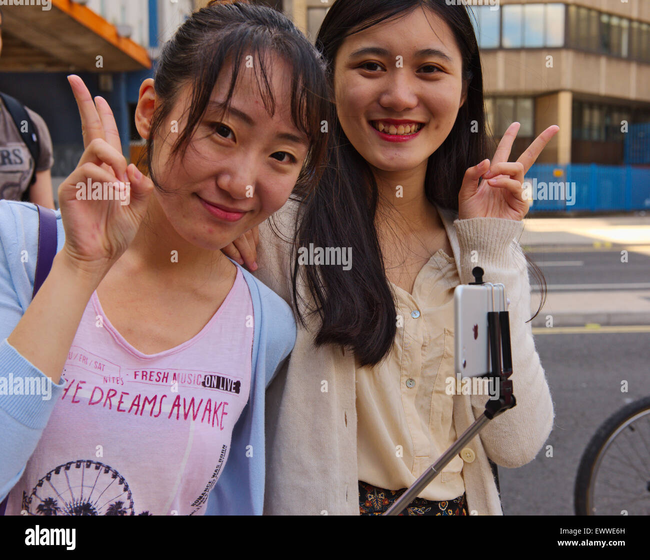 Two pretty Asian women giving “V” sign Stock Photo