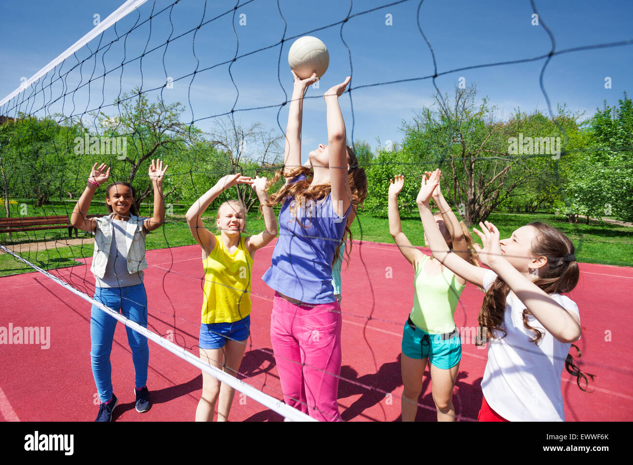 Teenagers are playing volleyball on the court Stock Photo Alamy
