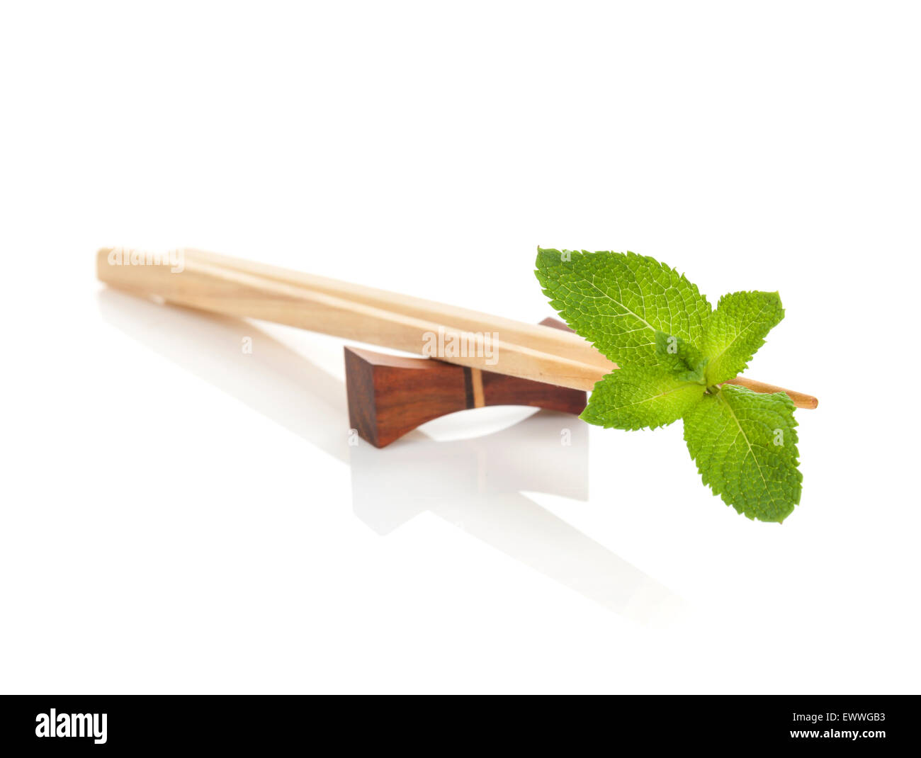 Sushi chopsticks with mint leaves. Isolated on white background Stock