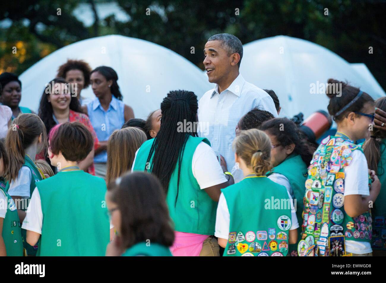 U.S. President Barack Obama talks with Girl Scouts during the first-ever White House Campout with fifty fourth-grade girls as part of the Let's Move! Outside initiative on the South Lawn of the White House June 30, 2015 in Washington, DC. In addition to the campout the girls enjoyed stargazing activity with scientists and astronaut Cady Coleman. Stock Photo