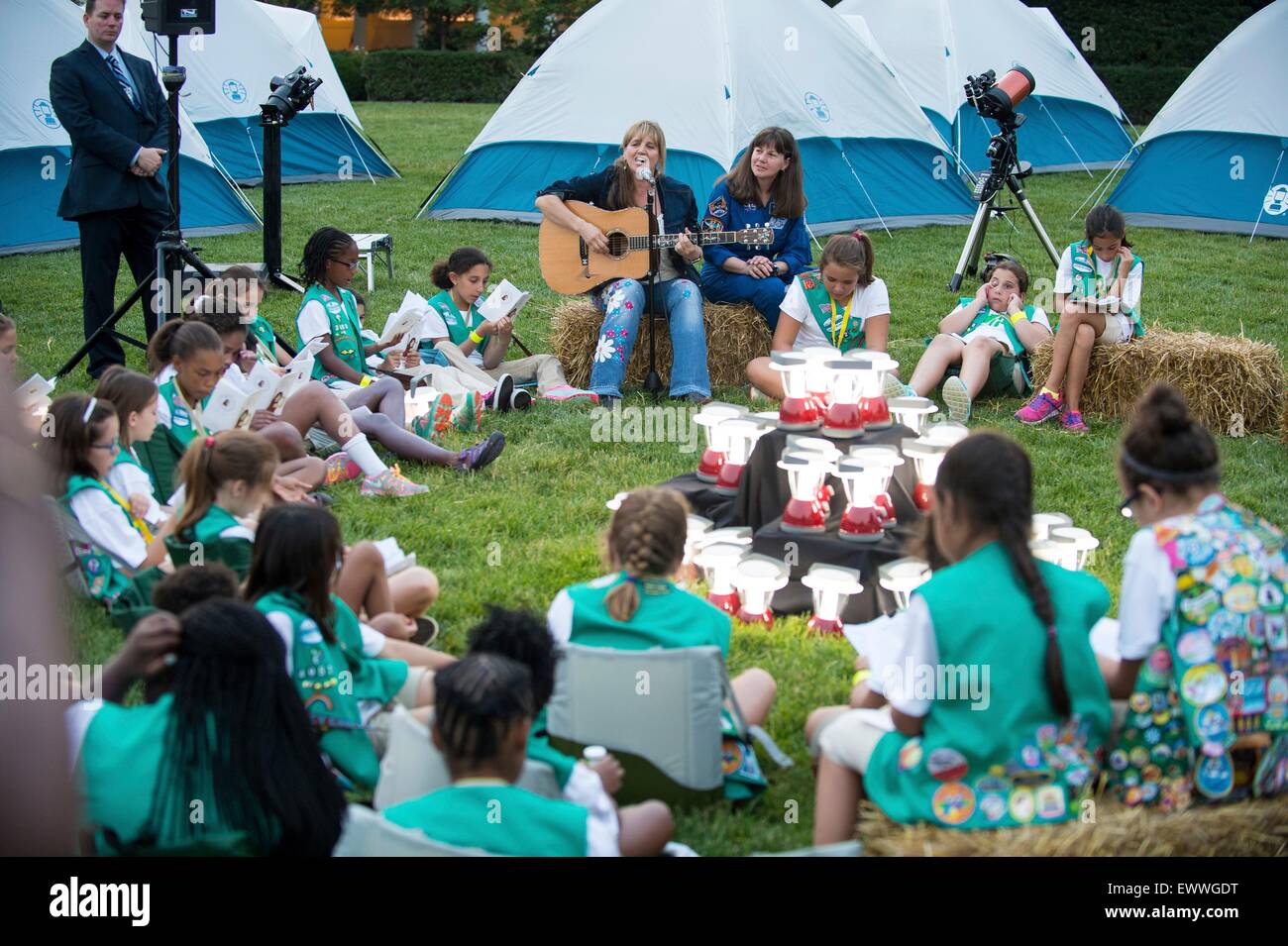 Singer Teresa Suber performs as Astronaut Cady Coleman looks on during the first-ever White House Campout with fifty fourth-grade Girl Scouts as part of the Let's Move! Outside initiative on the South Lawn of the White House June 30, 2015 in Washington, DC. In addition to the campout the girls enjoyed stargazing activity with scientists and astronaut Cady Coleman. Stock Photo