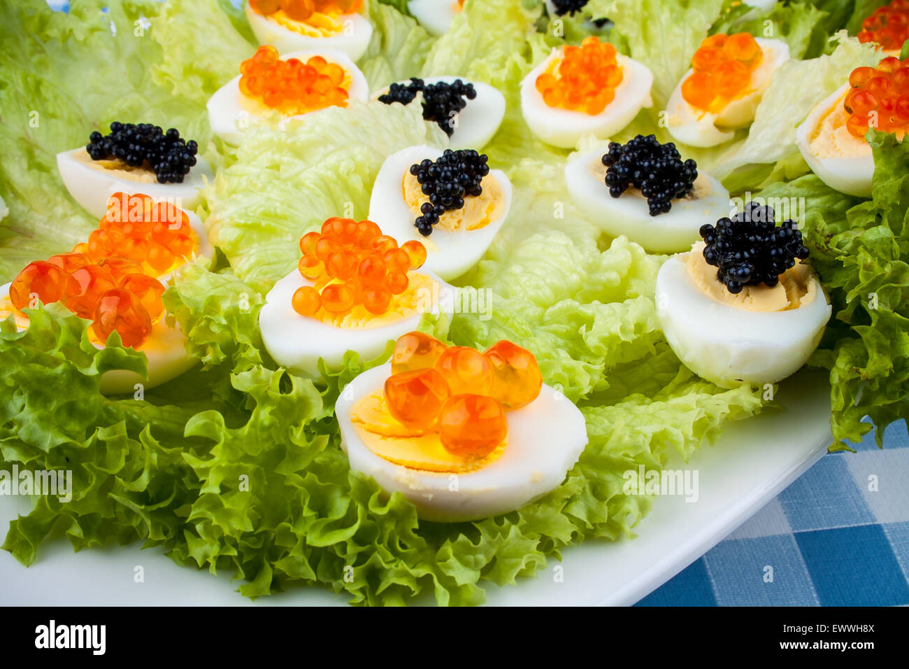 Quail eggs served with trout, salmon and sturgeon caviar, top view Stock Photo