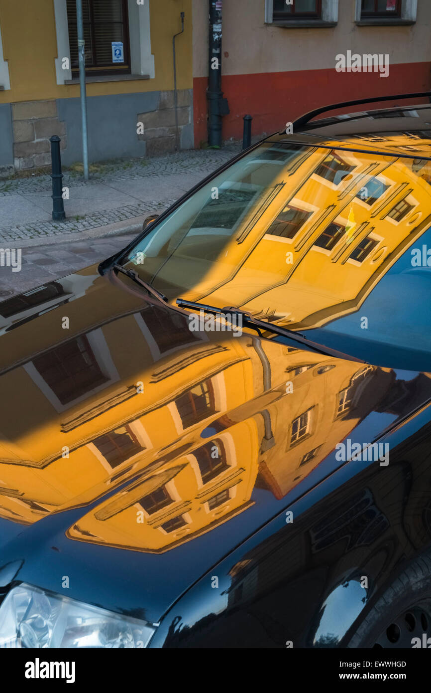 Brightly coloured buildings reflected on car bonnet and window, Wroclaw, Poland Stock Photo