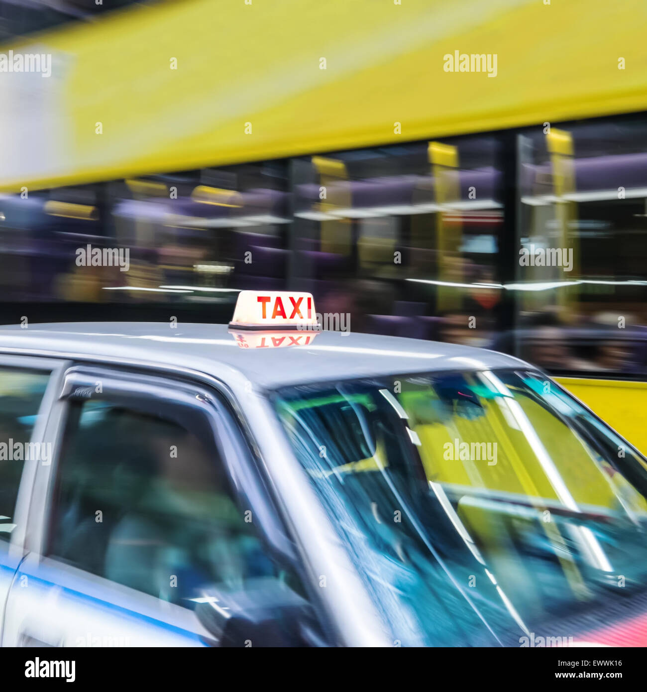 Abstract cityscape blurred background with taxi car and public bus at city street. Hong Kong Stock Photo