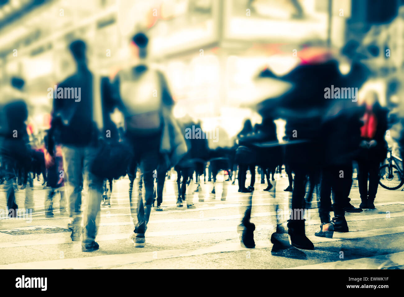 Blurred image of people moving in crowded night city street. Art toning abstract urban background. Hong Kong Stock Photo