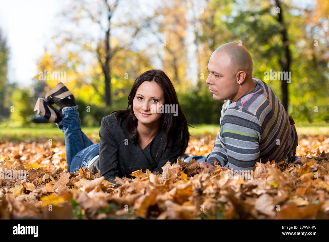 Happy Couple Sitting Together In The Woods During Autumn Stock Photo ...