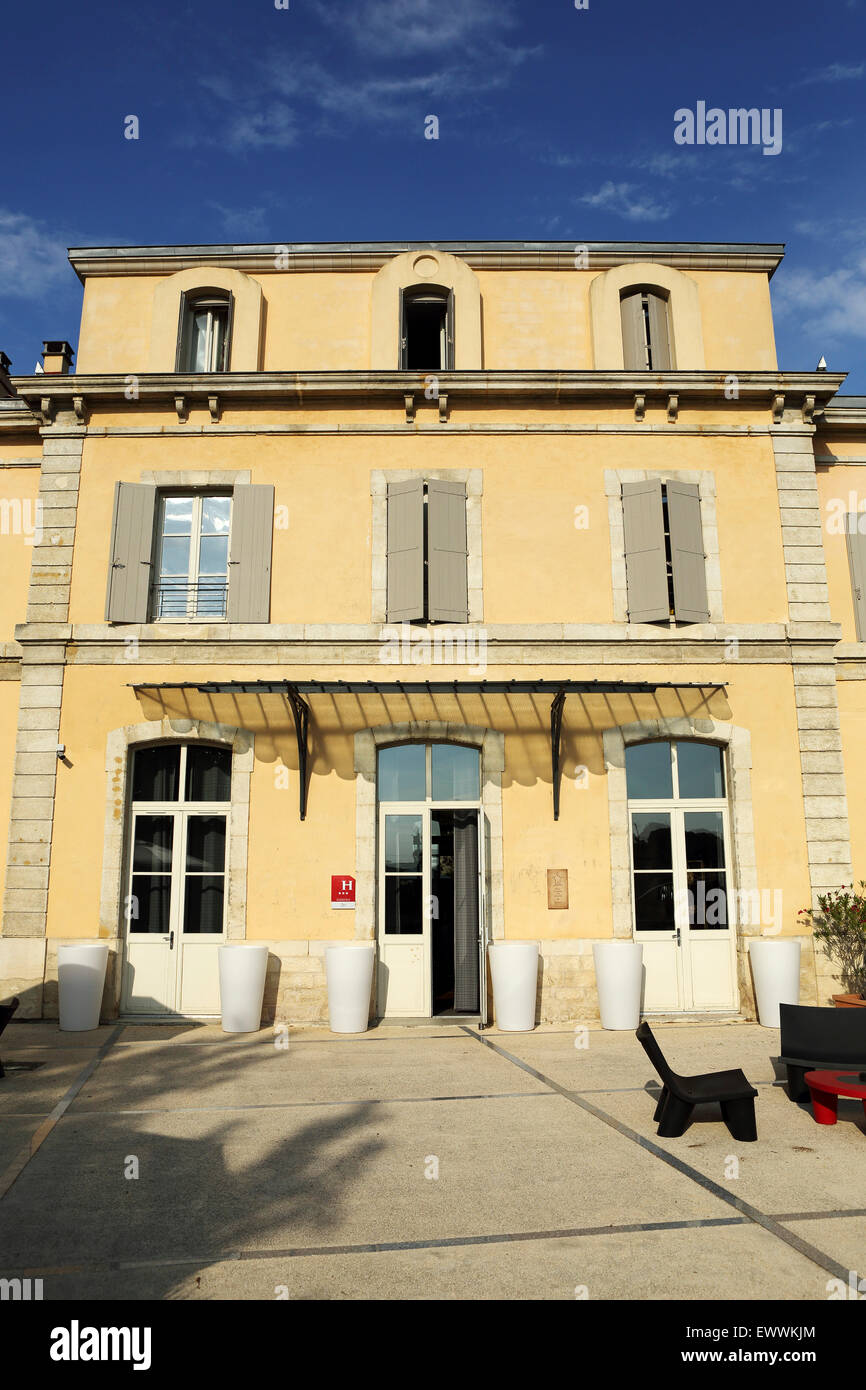 Facade of the Hotel Estelou in Sommieres, France. The hotel is in a former railway station built in the 1870s. Stock Photo
