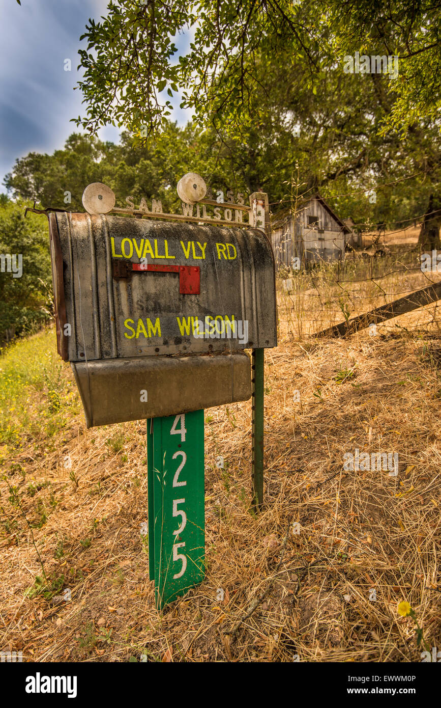 Rusted bristol mailbox on roadside Stock Photo