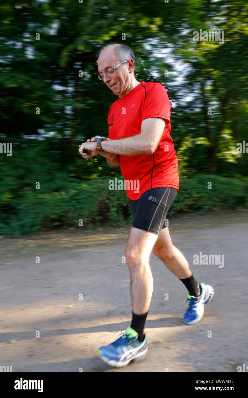 Runner controlling distance, heart rate, burned fat e.c. by a digital