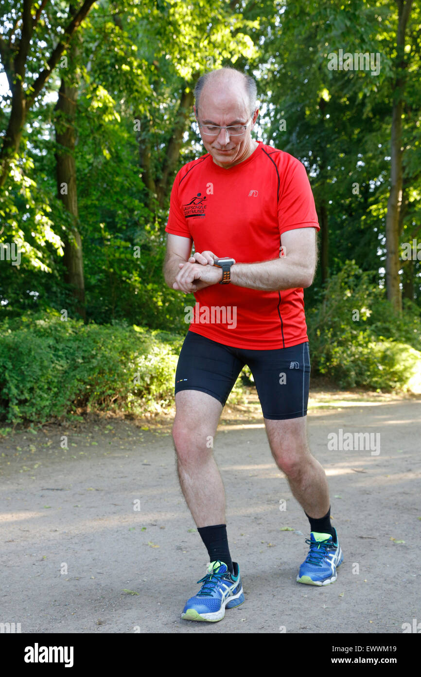 Runner controlling distance, heart rate, burned fat e.c. by a digital