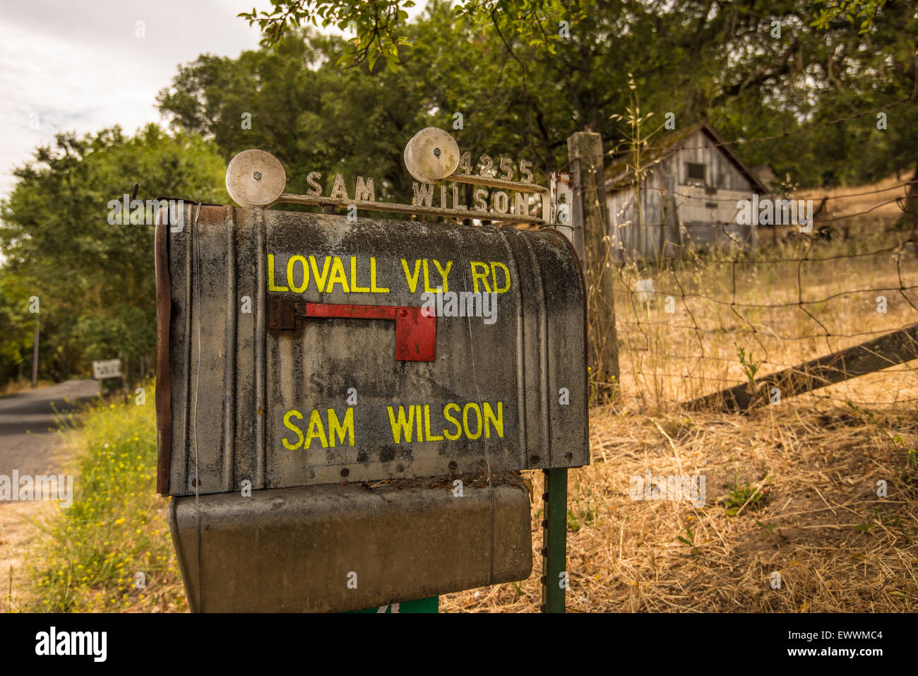 Rusted bristol mailbox along rural road Stock Photo