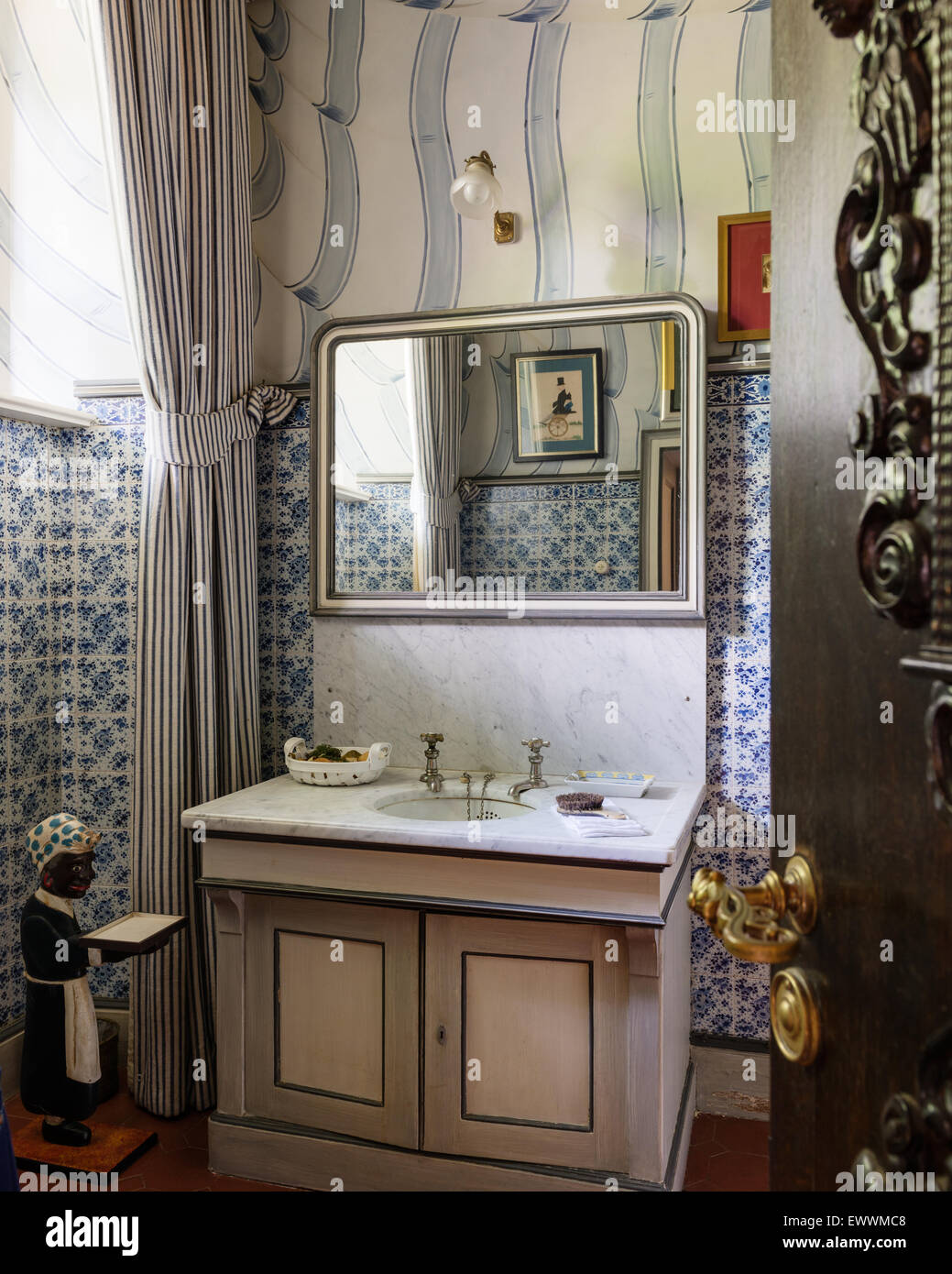 Marble topped vanity unit in cloakroom with tiled walls Stock Photo