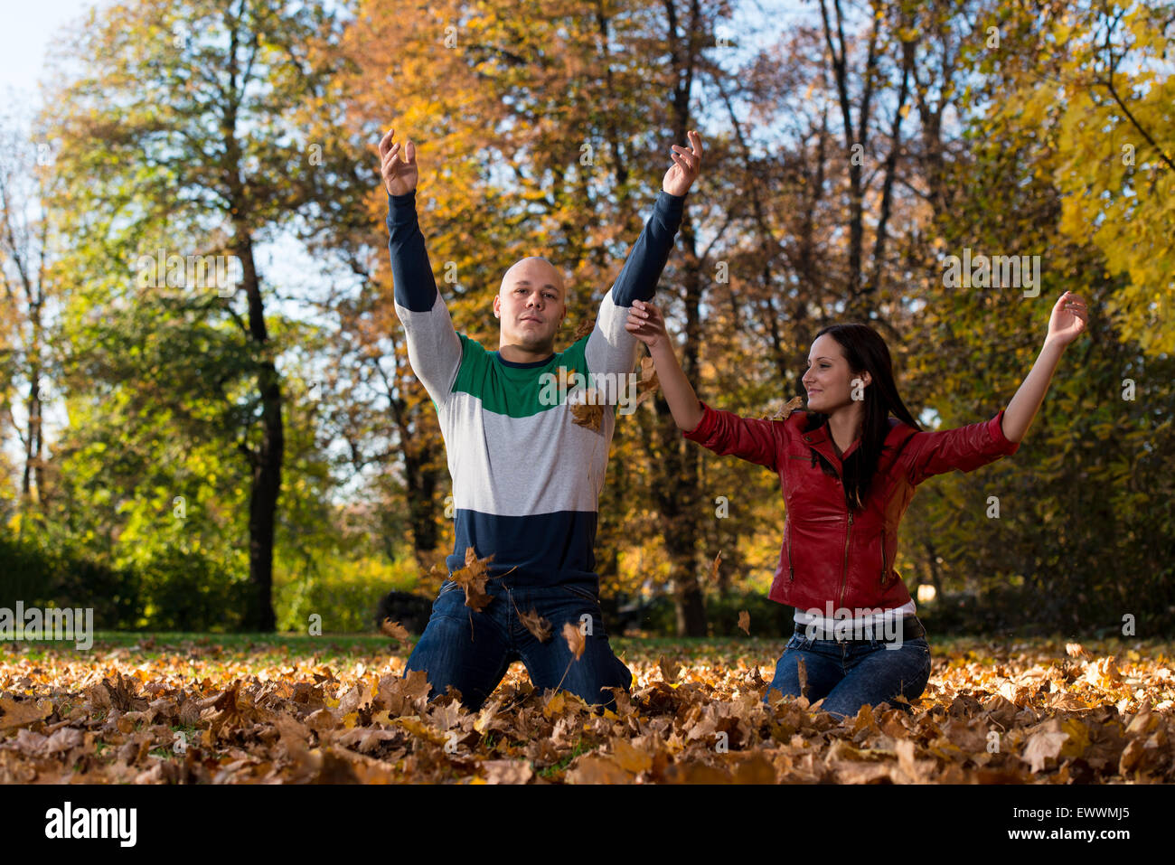 Couple Throwing Leaves In The Air Stock Photo Alamy