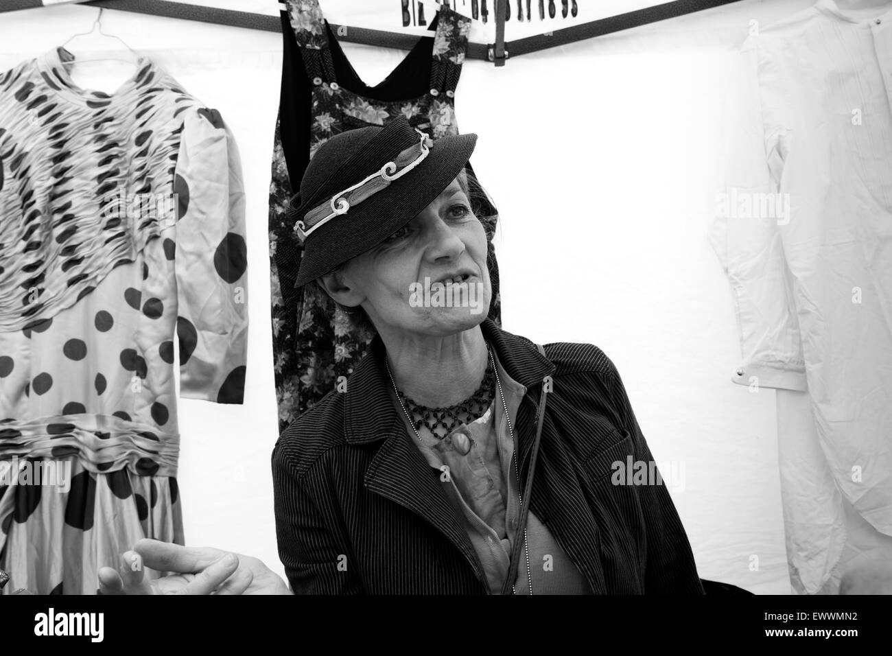 French market stall holder selling ladies fashion wear at Annecy market in France. french wearing stylish retro hat hats Stock Photo