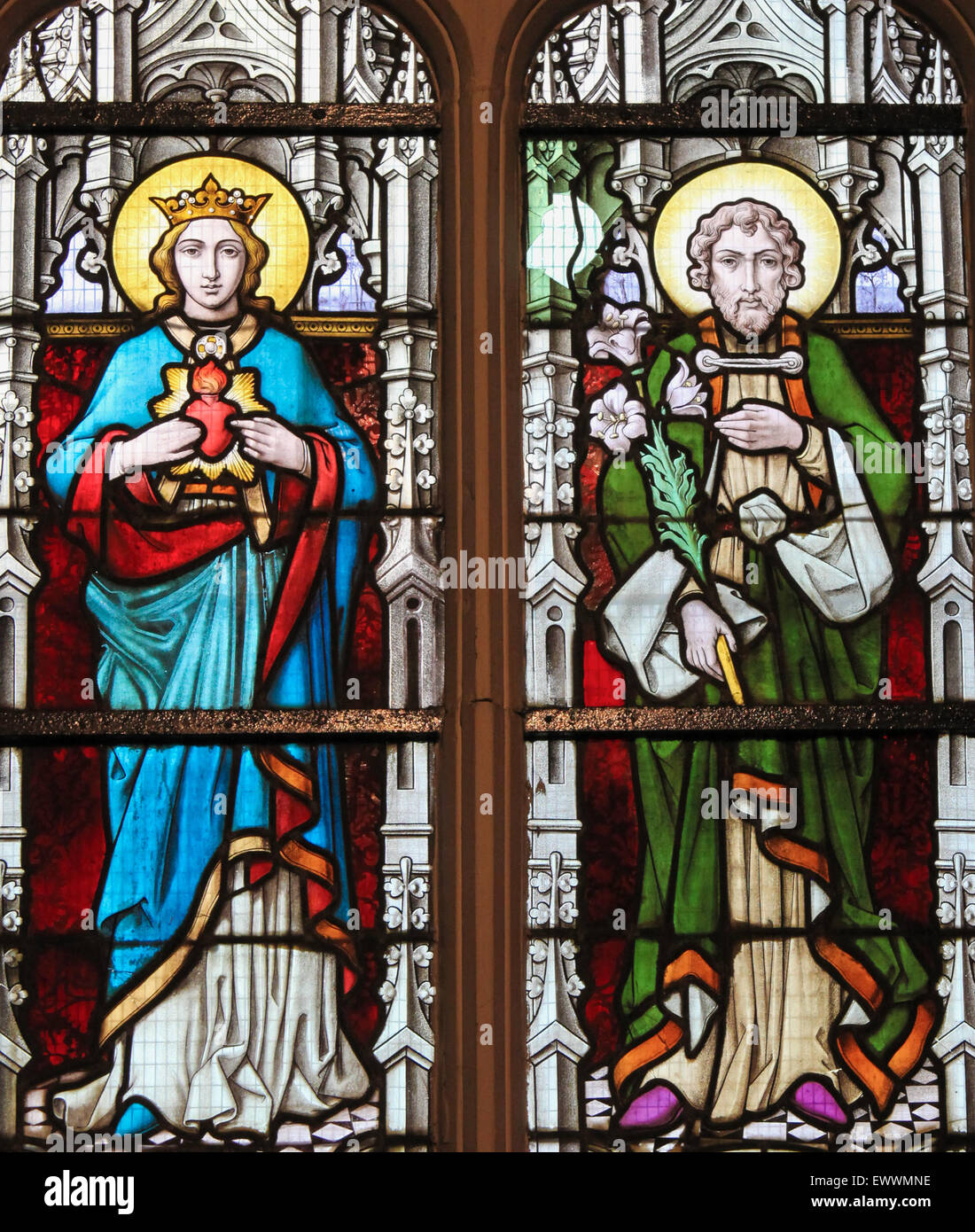 Stained glass window depicting Mother Mary and Saint Joseph, parents of Jesus Christ, in the Church of Stabroek, Belgium. Stock Photo