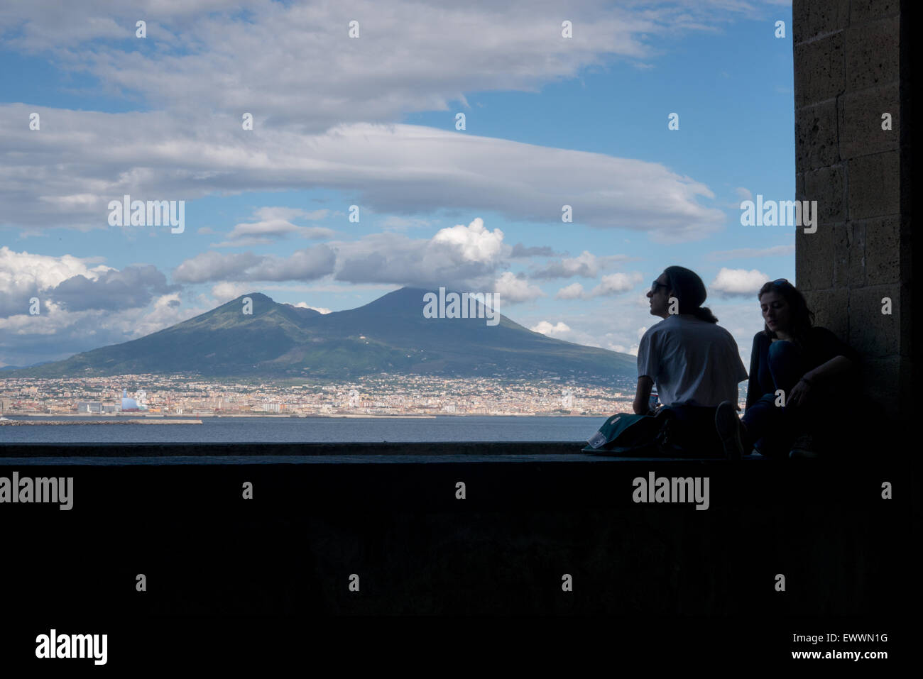 Two girls looking at the panorama and the Vesuvio vulcan from Castel dell´Ovo, Naples Stock Photo