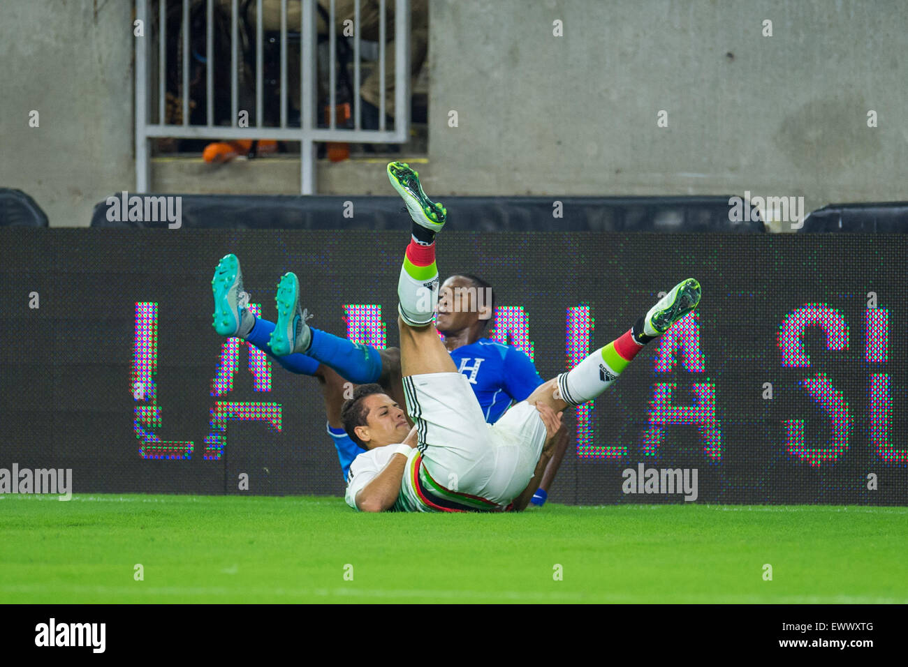 Houston, TX, USA. 1st July, 2015. Mexico forward Javier Hernandez (14) injures his shoulder in a collision with Honduras defender Brayan Beckeles (21) during the 1st half of an international soccer match between Honduras and Mexico at NRG Stadium in Houston, TX. Trask Smith/CSM/Alamy Live News Stock Photo