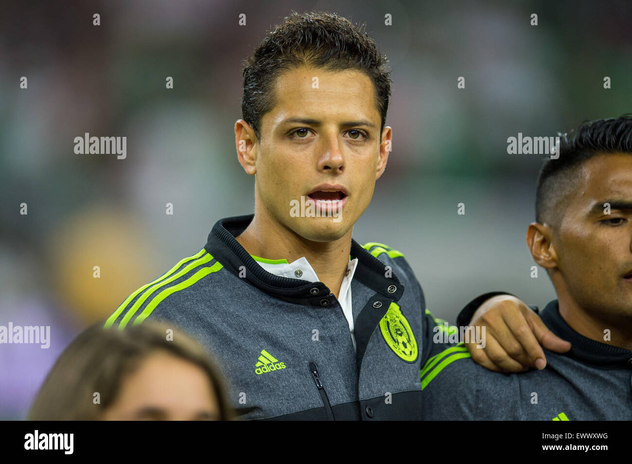 Houston, TX, USA. 1st July, 2015. Mexico forward Javier Hernandez (14) sings the national anthem prior to an international soccer match between Honduras and Mexico at NRG Stadium in Houston, TX. Trask Smith/CSM/Alamy Live News Stock Photo
