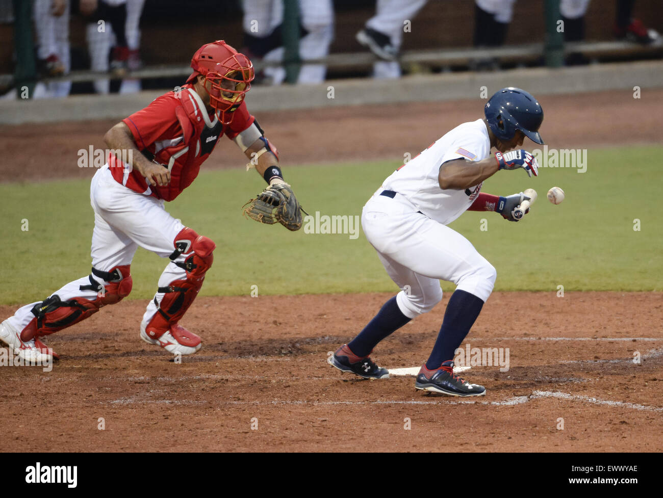 Cary, North Carolina, USA. 1st July, 2015. Corey Ray, right, of USA bunts a ball against catcher Yulexis La Rosa, left, of Cuba during game 1 of the USA Collegiate National Team versus Cuba National Team series played in Cary, N.C. on Wednesday, July 1, 2015. USA won 2-0. © Fabian Radulescu/ZUMA Wire/ZUMAPRESS.com/Alamy Live News Stock Photo