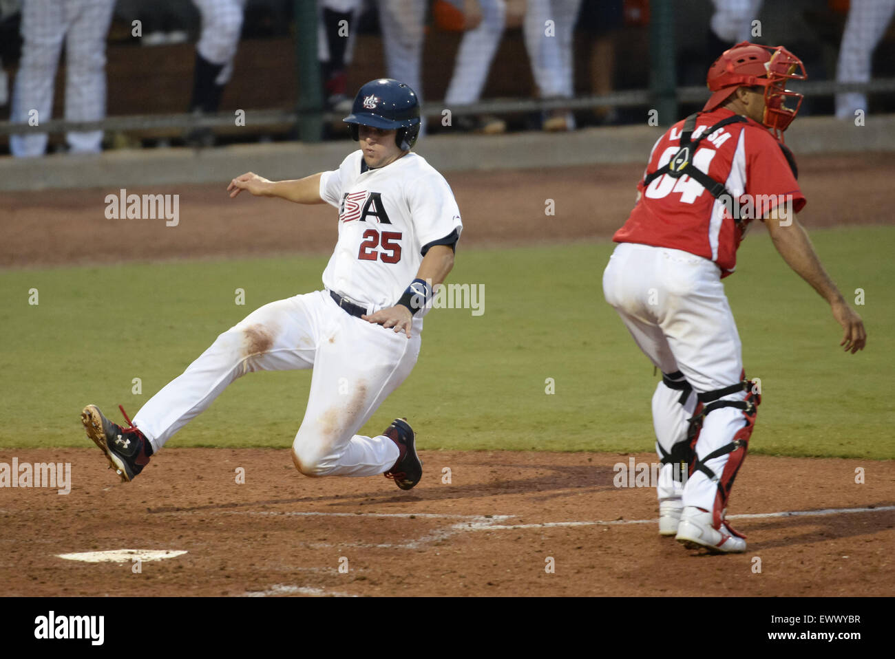 Cary, North Carolina, USA. 1st July, 2015. Chris Okey (25) of USA slides to home base against catcher Yulexis La Rosa, right, of Cuba to score the first point for the USA during the 6-th inning of game 1 of the USA Collegiate National Team versus Cuba National Team series played in Cary, N.C. on Wednesday, July 1, 2015. USA won 2-0. © Fabian Radulescu/ZUMA Wire/ZUMAPRESS.com/Alamy Live News Stock Photo