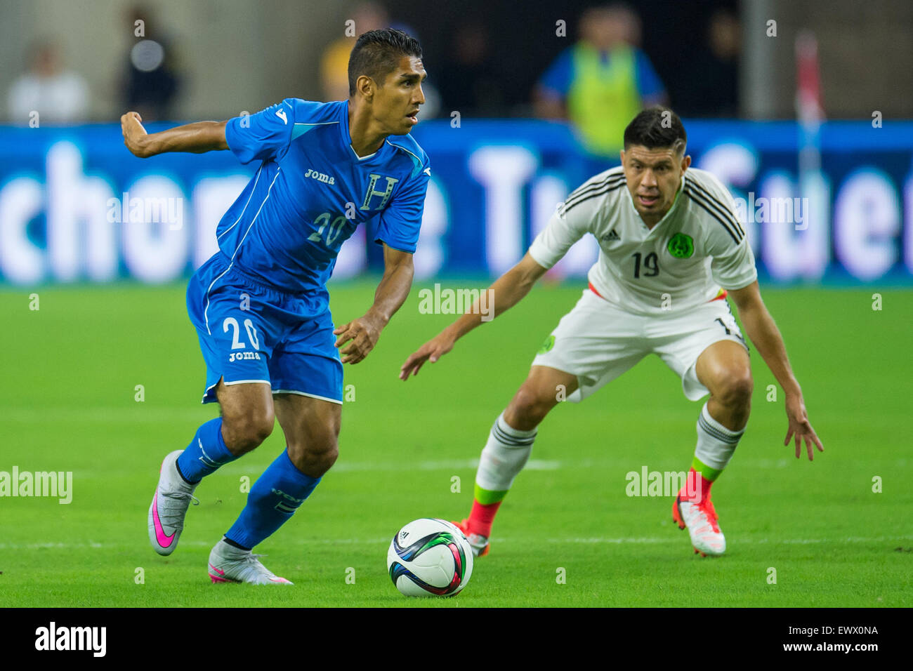 July 1, 2015: Honduras midfielder Jorge Claros (20) controls the ball in front of Mexico forward Oribe Peralta (19) during the 2nd half of an international soccer match between Honduras and Mexico at NRG Stadium in Houston, TX. The game ended in a 0-0 draw.Trask Smith/CSM Stock Photo