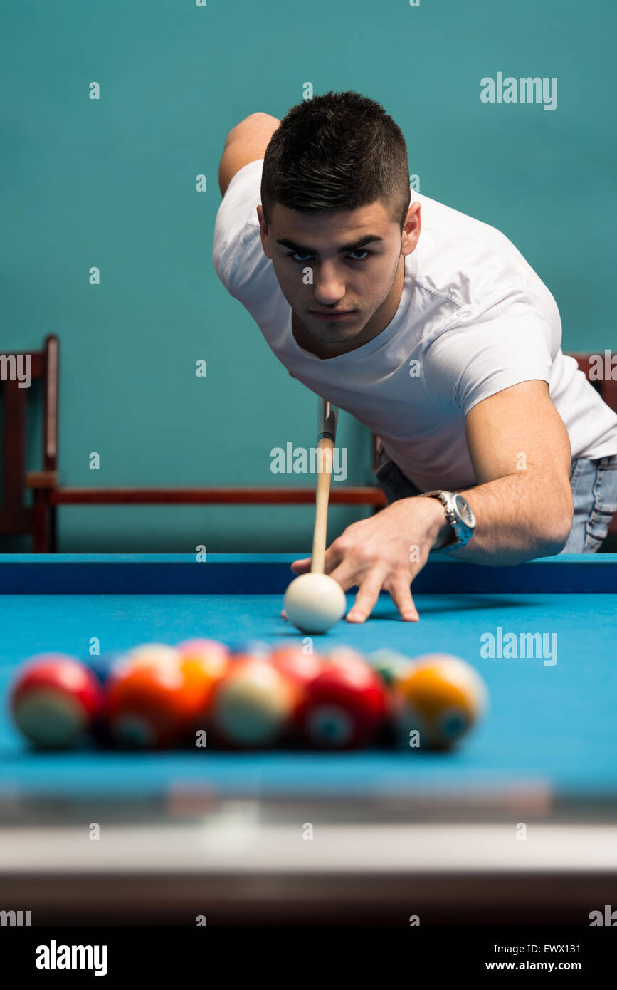 Young Men Lining To Hit Ball On Pool Table Stock Photo Alamy