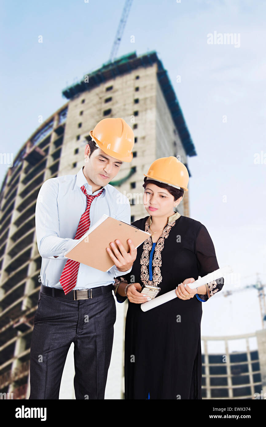 2 indian Architect Construction Site Clipboard Discussion Stock Photo